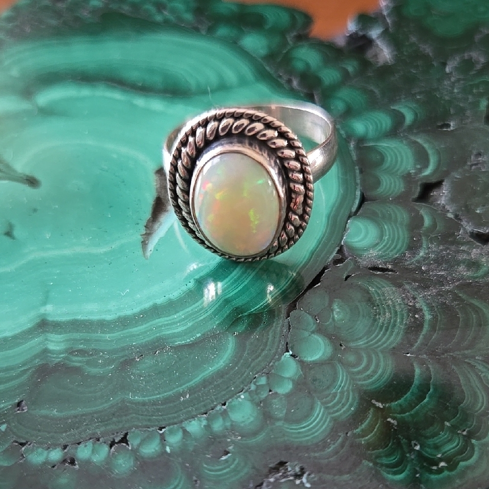 Vintage Sterling Silver and White Opal Ring with Intricate Detailing.